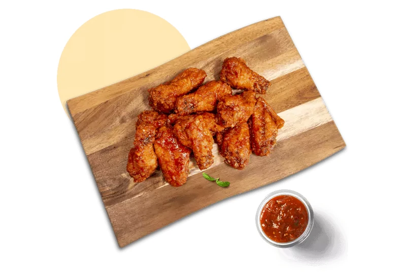 Jumbo chicken wings with dipping sauce at Queen's Pizza & Wings in Hamilton, ON